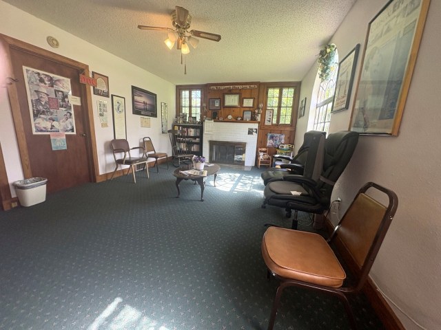 Waiting room with fireplace and natural light.