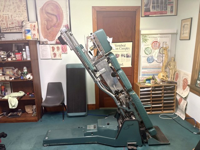 Specialized green chiropractic adjustment table.